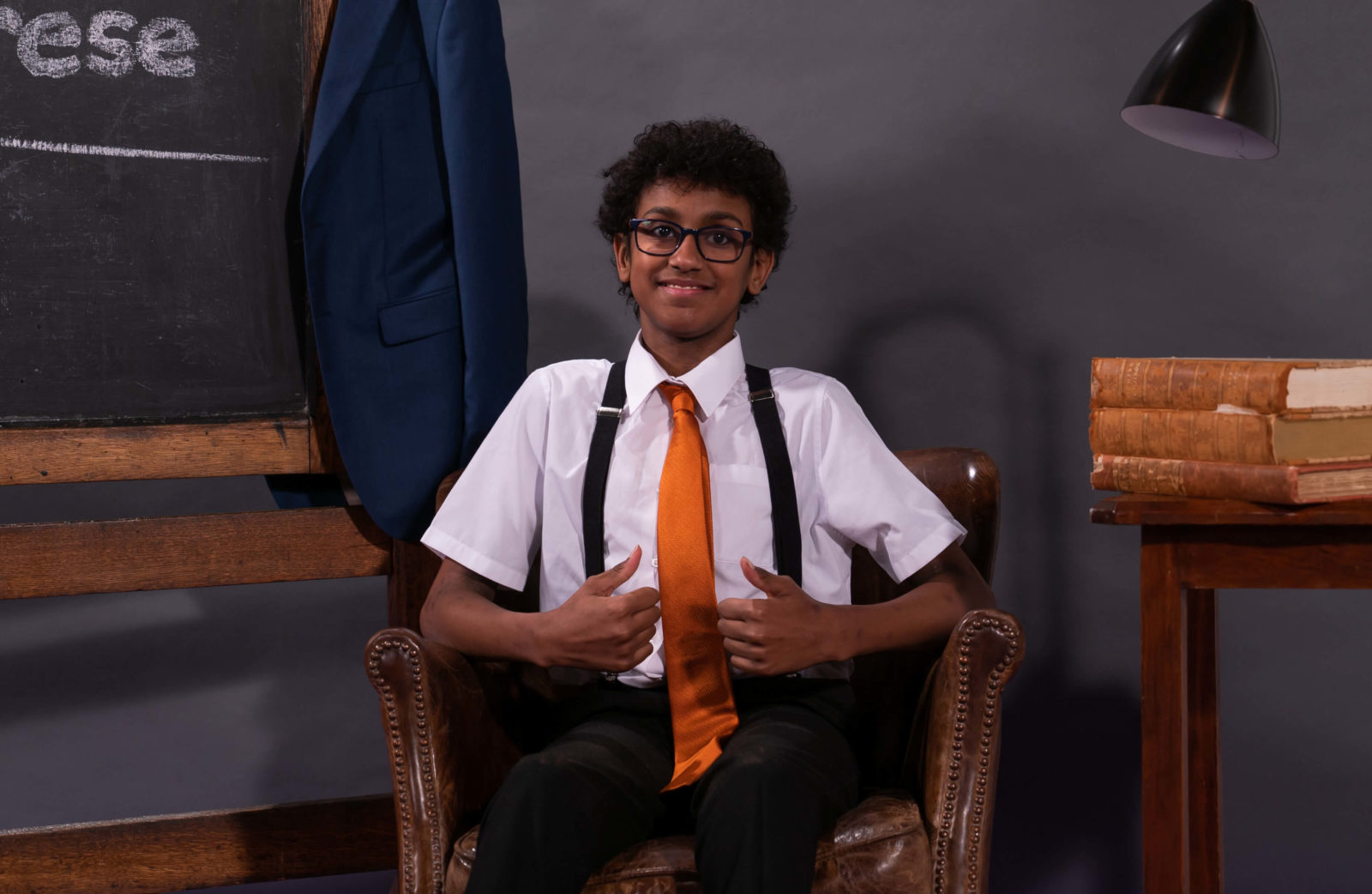 Tyrese, a young boy, waiting in a chair to teach sign language